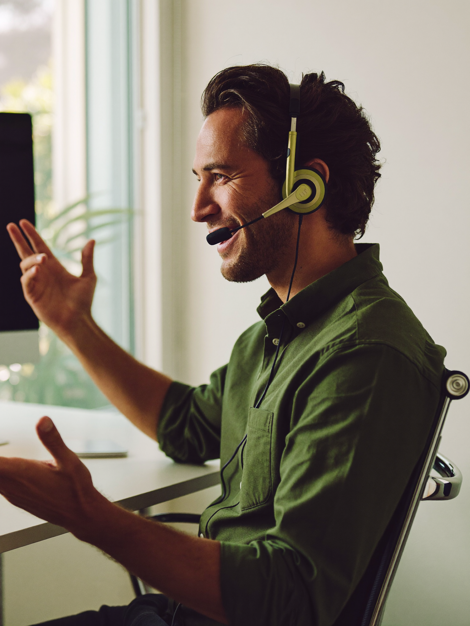 A producer selling on the phone in a bright office