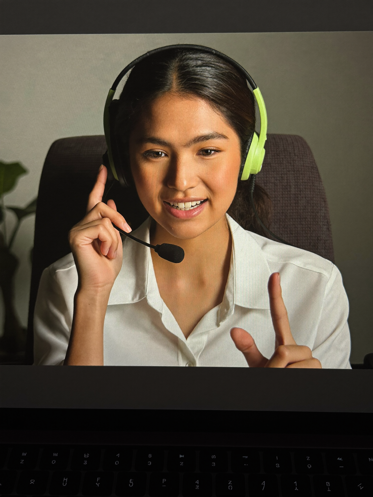 A young producer practicing calls with a headset